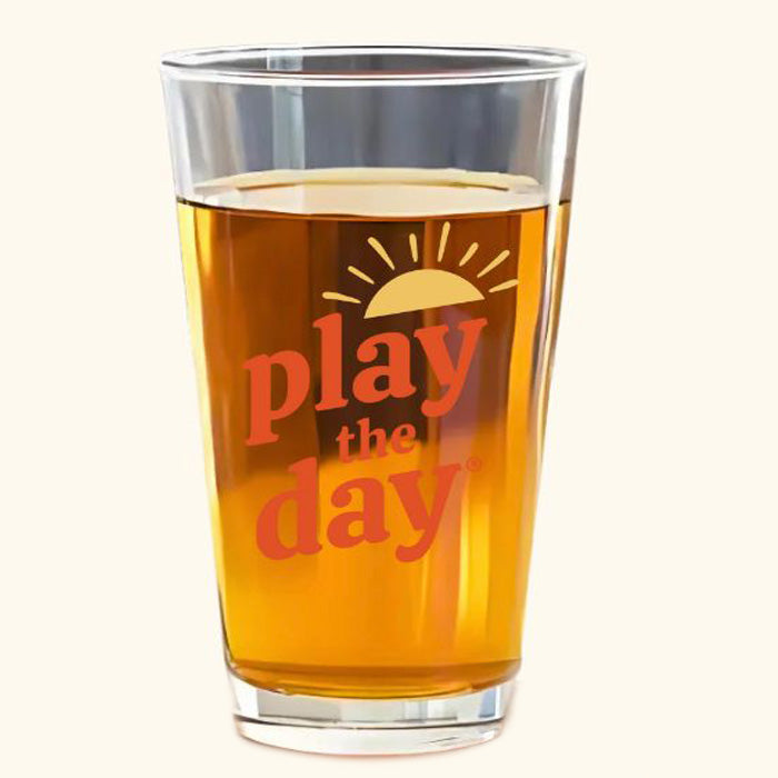 16 oz pint glass with orange and yellow Play the Day® logo screen printed on front