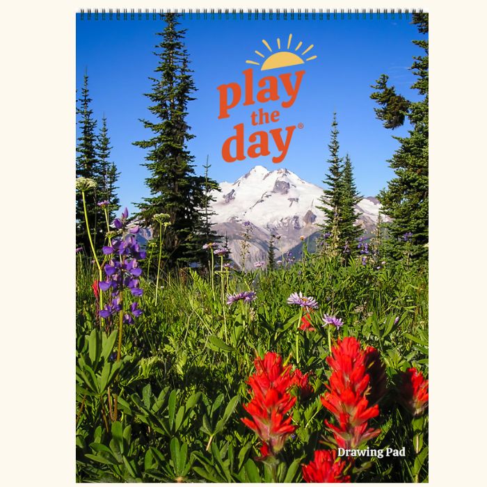 Cover of the Play the Day® Art Pad featuring Mount Baker with wildflowers and pine trees in the foreground.