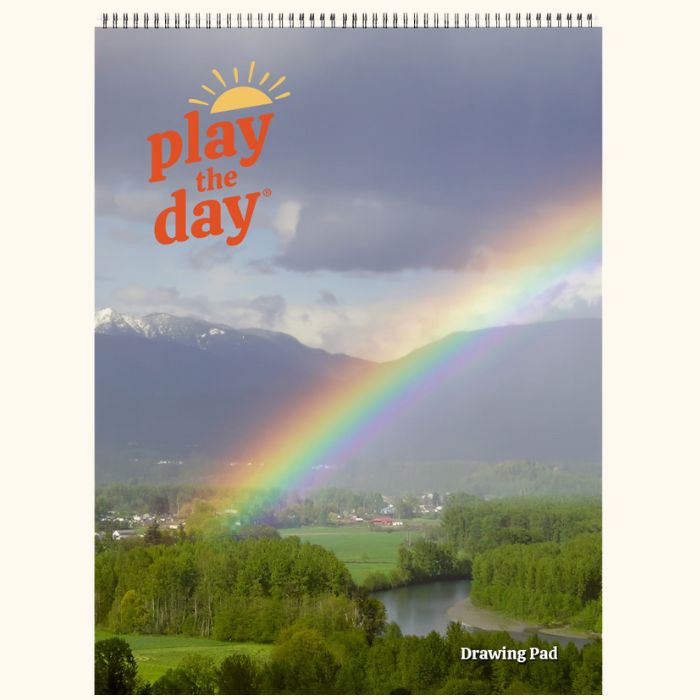9 x 12 Play the Day® art pad cover with a rainbow arching over the Skykomish River valley and farmland