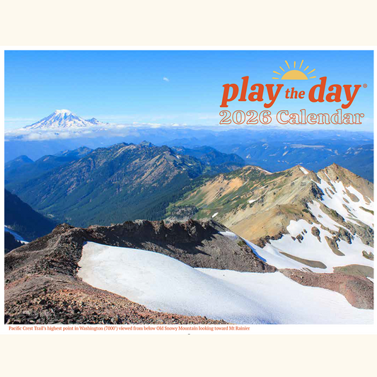 Cover of the Play the Day® 2026 Calendar featuring Mount Rainier and the Pacific Crest Trail, viewed from Old Snowy Mountain.
