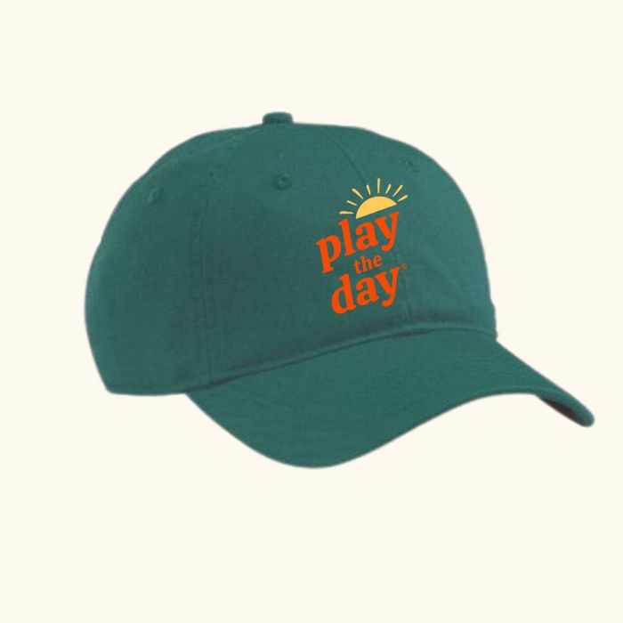 Forest green Play the Day® organic cotton cap with embroidered logo and sun graphic, angled view