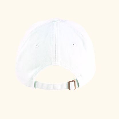 Back view of white Play the Day® cap with adjustable metal strap and organic cotton twill fabric