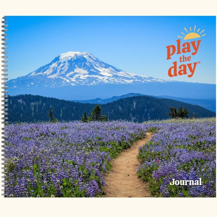 Play the Day® journal cover featuring a wildflower trail leading to a snow-covered mountain