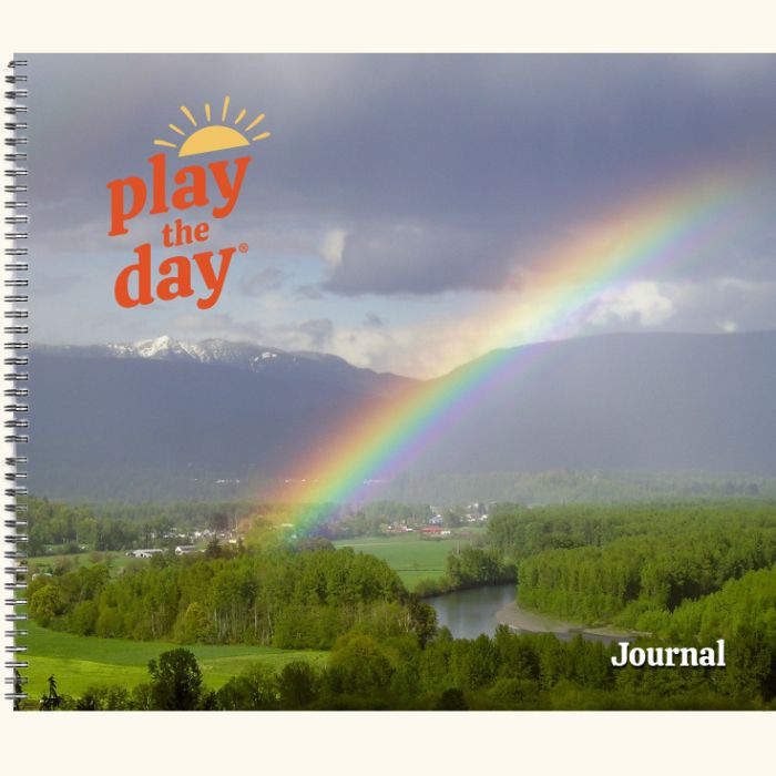 Play the Day® journal cover with rainbow arching over the Skykomish River valley