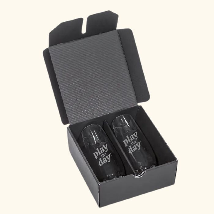 Set of two deep-etched Play the Day® stemless champagne flutes in black gift box