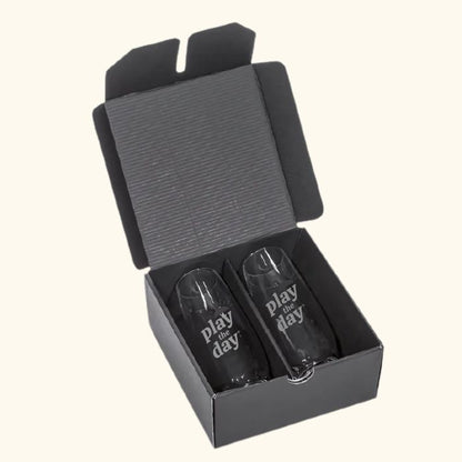 Set of two deep-etched Play the Day® stemless champagne flutes in black gift box