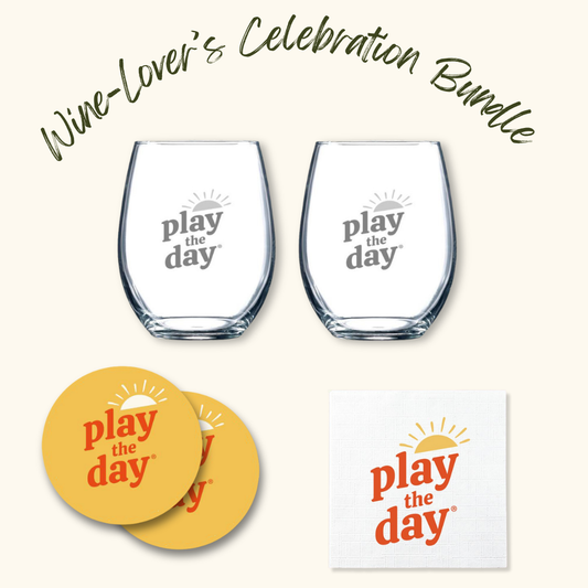 Play the Day® Wine-Lover’s Celebration Bundle with two stemless wine glasses, two recycled-paper coasters, and napkins featuring the Play the Day® logo.